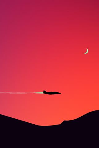 夕暮れの空を飛ぶ飛行機