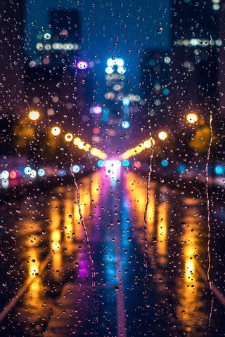 ガラス越しの雨の夜景|雨のiPhone壁紙